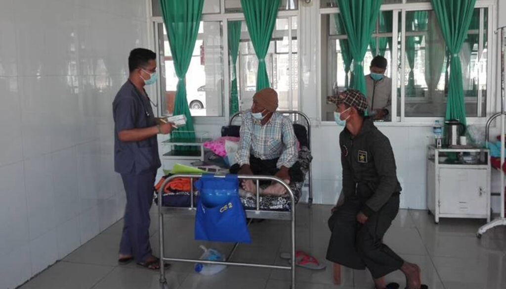 One of the local inpatients is seen receiving medical treatment at the military hospital.