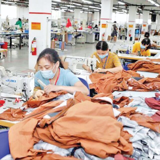 Myanmar employees seen working at a garment factory.